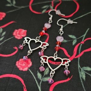Dangling earrings with red, white, and pink beads and heart with wings
